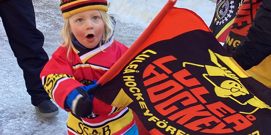 förskolebarn viftar med hockeyflagga